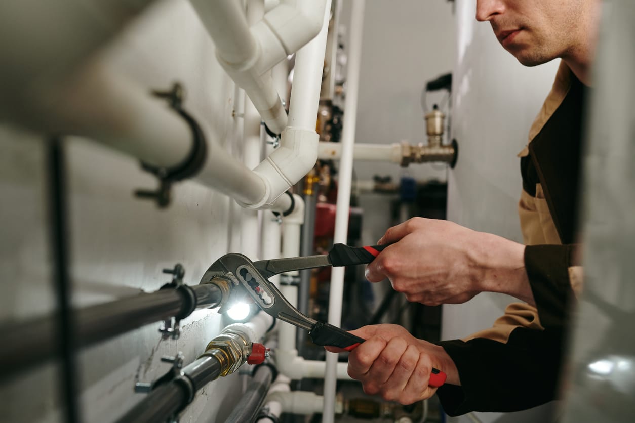 Plumbers maintaining commercial plumbing pipes in Escondido