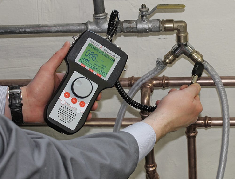 Plumber testing pipes with electronic leak detection equipment in Escondido