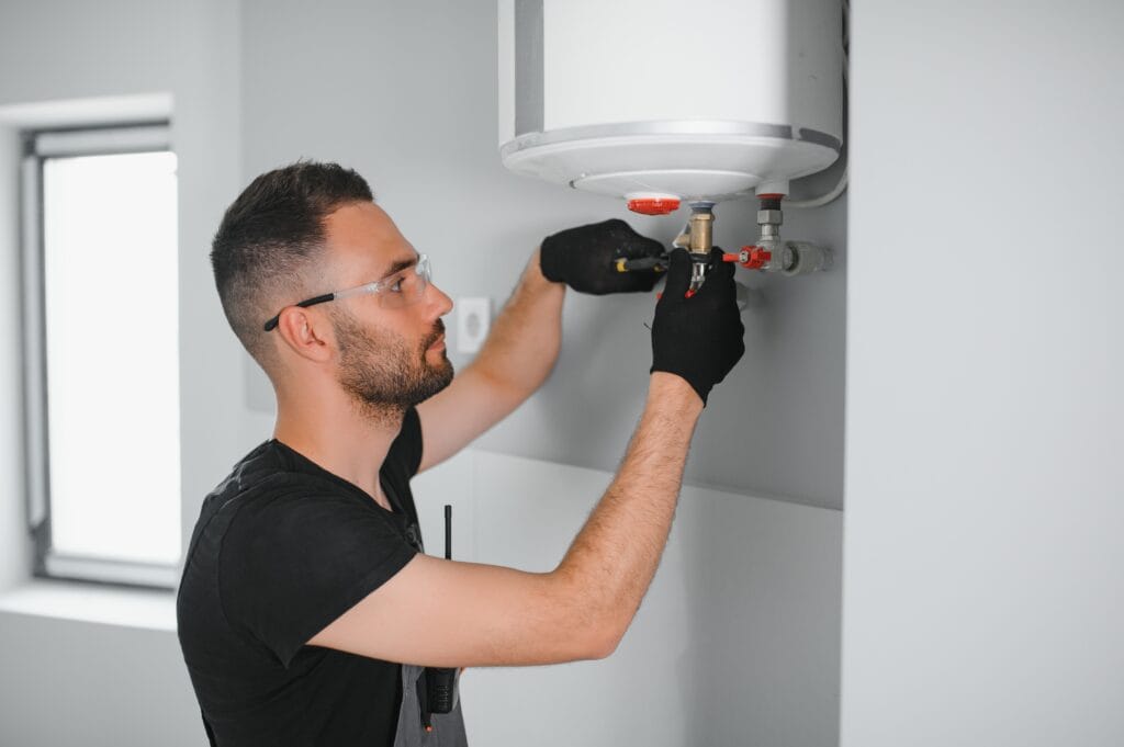 Technician performing water heater maintenance in Escondido